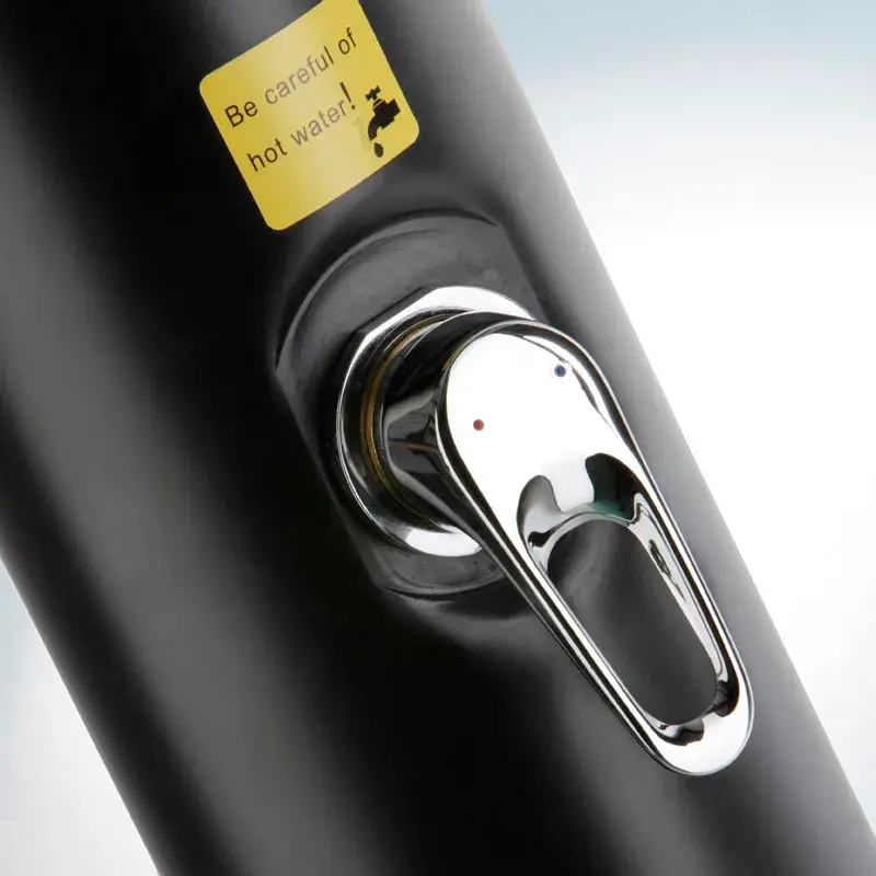 ar10250-2 | PisciManía Close-up of a chrome single-handle faucet on a dark fixture with a yellow sticker that says 'Be careful of hot water'.