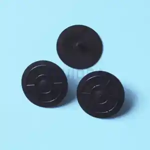 wr000189-2 | PisciManía Three small black circular plastic discs with a raised center and radial spokes on a light blue background.